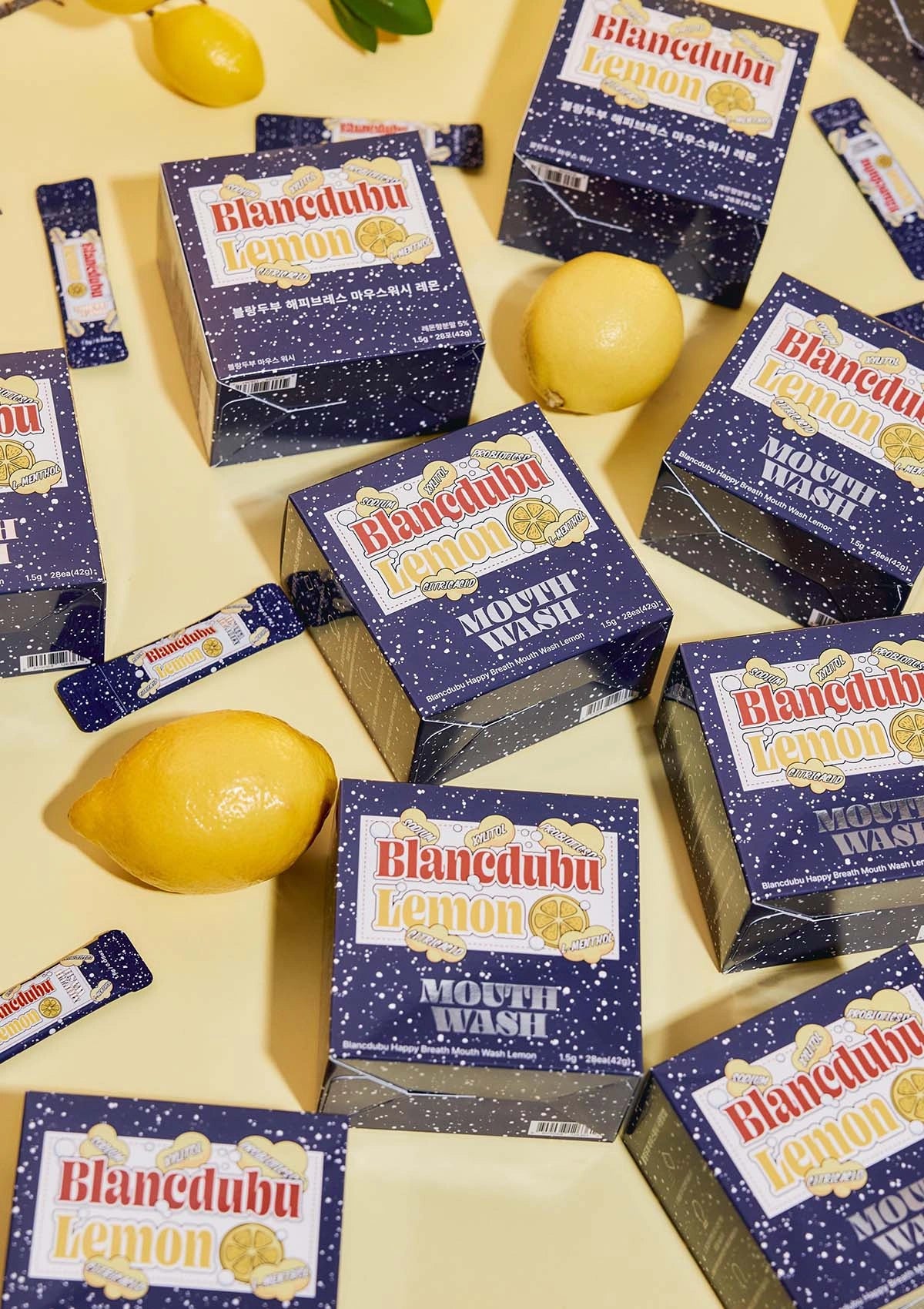 Blendedub Lemon mouthwash boxes on a yellow background with lemons.